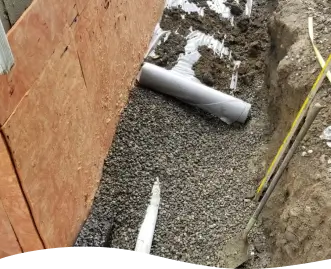 Footing drain piping and gravel in ground